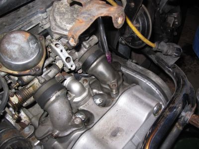 Unbolting the intake pipes from the head.
Keywords: gl1200;goldwing;1984
